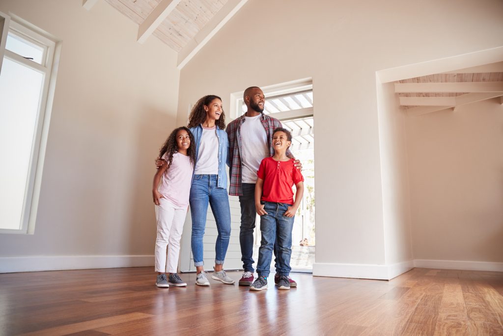 Family,Opening,Door,And,Walking,In,Empty,Lounge,Of,New